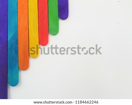 Colorful ice cream sticks on white background. wooden texture. ideal as wallpaper and backdrop.