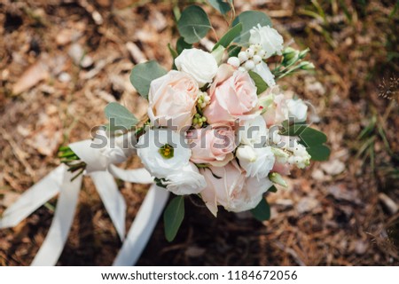 bouquet of the bride on the ground in the forest