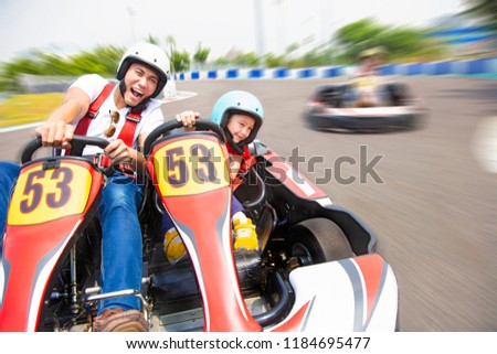father and daughter driving go kart on the track Royalty-Free Stock Photo #1184695477
