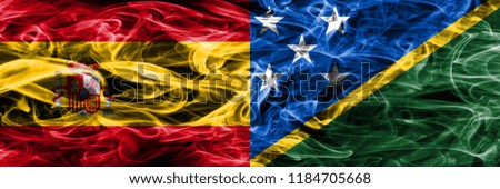 Spain vs Solomon Islands smoke flags placed side by side. Thick colored silky smoke flags of Spanish and Solomon Islands