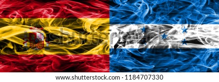 Spain vs Honduras smoke flags placed side by side. Thick colored silky smoke flags of Spanish and Honduras