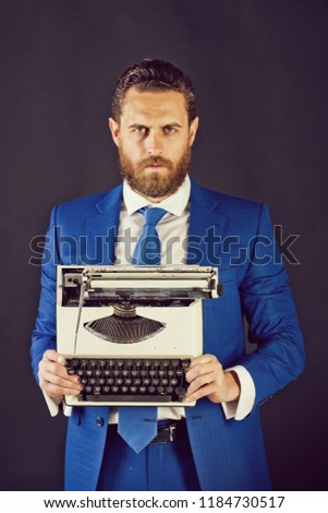 man with typewriter in fashion blue business suit on grey background