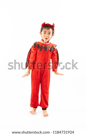 Portrait Asian little cute girl in evil costume for Halloween festival with pumpkin