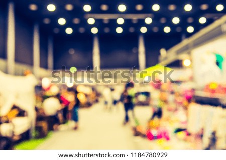 Abstract blur image of People walking at shopping mall with bokeh for background usage . (vintage tone)