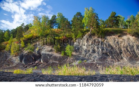 Nature photography landscape of rocks with green trees growing on a slope