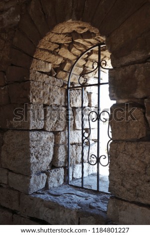 Arched window in a stone building. Old mausoleum of Hussein Bey. cemetery of Alsirat, Bashkortostan,Russia.