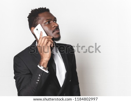 Close up portrait of afro american man looking at his mobile phone. business negotiations by phone