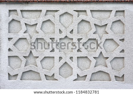Islamic design cast in concrete on a building, traditional arabic ornament, bas-relief