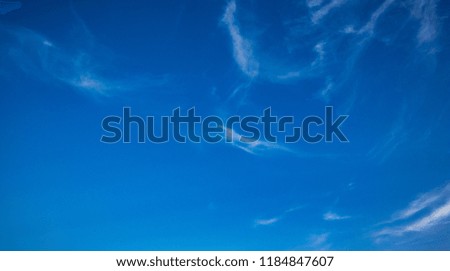 Wispy clouds in a bright blue sky over London, UK