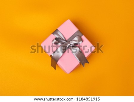 pink gift on yellow background