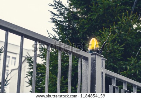 orange lamp flasher on metal gates