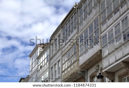 Typical Galician galerias, white enclosed balconies made of wood and glass, in the Betanzos city in Galicia, Spain