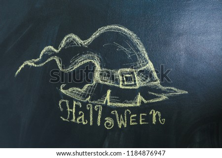 Drawing of witch hat with text "Halloween" on dark background