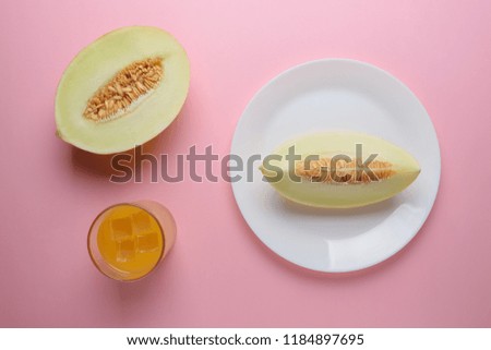 Melon sliced on pastel pink background. Minimal fruit concept.