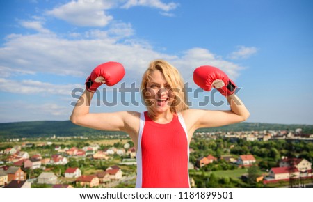 Girls power concept. Girl boxing gloves symbol struggle for female rights and liberties. Woman strong boxing gloves raise hands blue sky background. Feminism promotion. Fight for female rights.