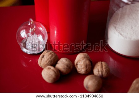red candles, walnuts, can with flour, rolling pin