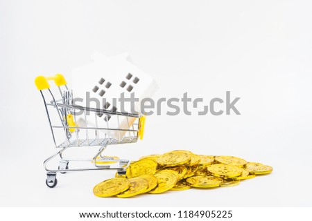 Shopping cart full of wooden white hose model, isolated on white background with copy space.Real estate concept, New house concept.Buying a house