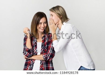 Young woman telling her friend some secrets. Best friend