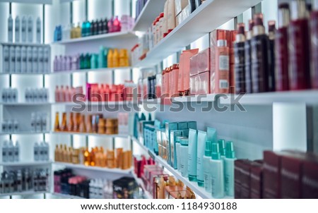 Modern beauty salon interior. Different cosmetics on shelves. Royalty-Free Stock Photo #1184930188
