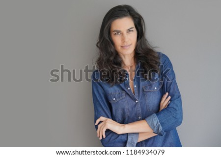 Brunette woman standing on grey background, isolated
