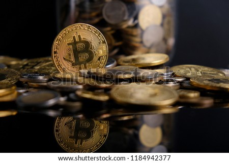 Physical version of Bitcoin (new virtual money). Exchange bitcoin for a dollar. Conceptual image for worldwide cryptocurrency and digital payment system.Golden Bitcoins. Ne