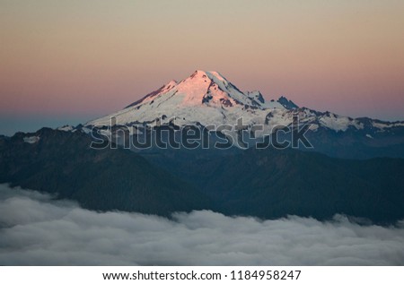 Mt Baker rises above the clouds in the North Cascades mountains in Washington State
