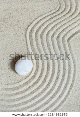 Single rock on sand background