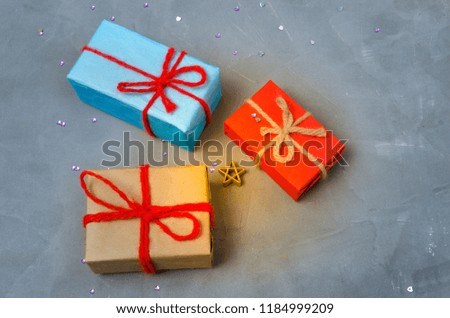 Three Christmas presents on the concrete floor.Holiday, new year and womens day,overhand.