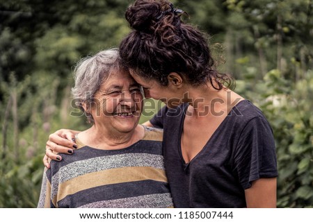 Young woman and her grandmother, very old woman. Two generations. Family love. Royalty-Free Stock Photo #1185007444