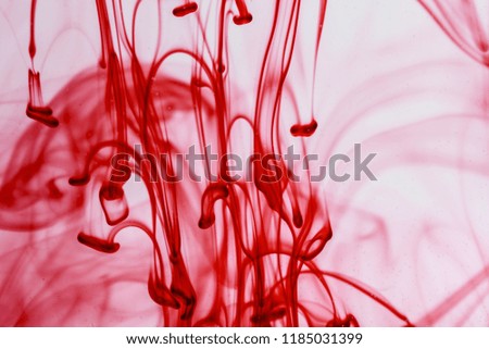 Red ink  liquid in water making abstract forms