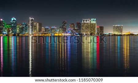 San Diego skyline, night, water reflections. Downtown cityscape with buildings reflecting, City of San Diego, California USA. Skyscrapers in downtown San Diego at night. Urban San Diego City at night.