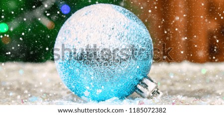 One blue New Year's ball in the snow. Christmas atmosphere.