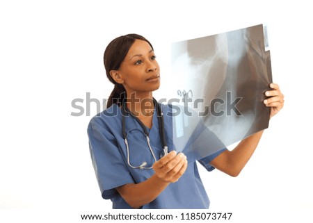 Young professional African-American doctor examining x ray of spinal cord