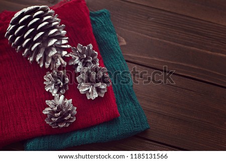 Silver Christmas cones New Year decorations for the Christmas tree on the plate with napkin on wood background
