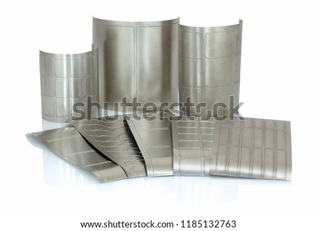 Different shapes of flexible die for die cutting on rotary, flexographic or in-line press printing machine used for label manufacturing isolated on white background with shadow reflection. Rotary dies Royalty-Free Stock Photo #1185132763