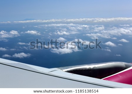 cloudy sky under the wing of an airplane