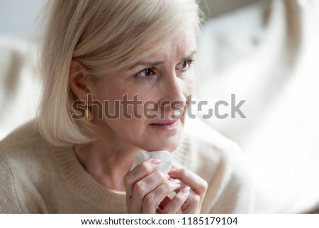 Sad frustrated mature old woman in tears feeling blue thinking of loneliness sorrow grief, upset thoughtful middle aged woman crying worried about problems, depressed senior widow mourning grieving Royalty-Free Stock Photo #1185179104