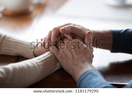 Old middle aged people holding hands close up view, senior retired family couple express care as psychological support concept, trust in happy marriage, empathy hope understanding love for many years Royalty-Free Stock Photo #1185179290