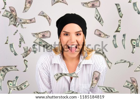 beautiful happy blond girl with money falling down