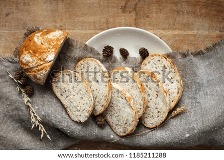 Bread is cut on a table with a sack and plate