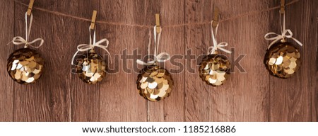 Christmas decorations on a wooden background. New Year decorations and free space for text on a wooden background. Holidays decor on the clothespins. Vintage texture.
