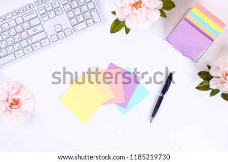 Multicolored sticky note stickers on a white desktop next to a coffee mug and a keyboard. Top view, flat layout.