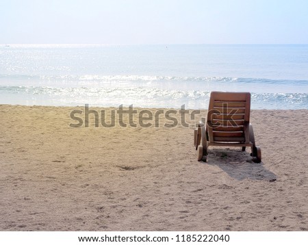 A Beach Chair face to sea and prepared for someone to take it for sunbathting