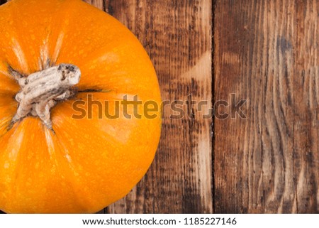 Orange pumpkin on retro wooden background. Copy space for text. Halloween, Thanksgiving day or seasonal autumnal concept. Close up, selective focus