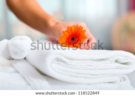 Maid doing room service in hotel, she is making up the beds Royalty-Free Stock Photo #118522849