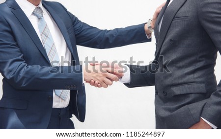 Handshake of 2 businessman in a black suit at the meeting room, office located the business center city.mergers and acquisitions for start greeting with good etiquette negotiation the success of both