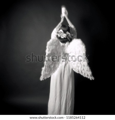 Dream like image of an angel. The photo is taken with a medium format fixed focus film camera. 