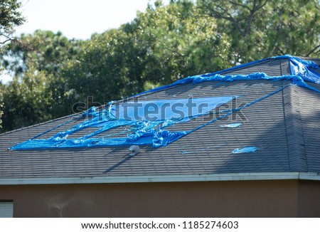 high winds and hurricane damage has caused leaks in your roof Royalty-Free Stock Photo #1185274603