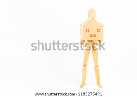 Wooden figurines posed standing holding paper hpuse box on white background with copy space.Real estate concept, New house concept.Buying a house