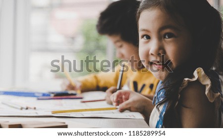Asian girl is painting on paper in Art group, for educational concept